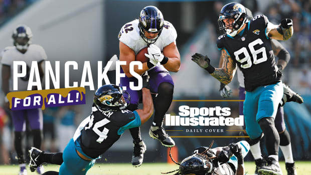 Pat Ricard leaps as he runs through the Jaguars defense